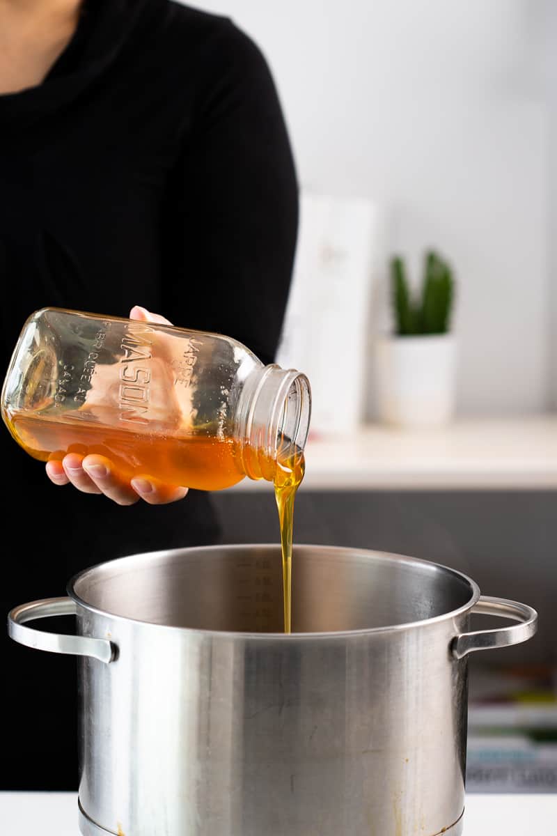 pouring the honey into a pot