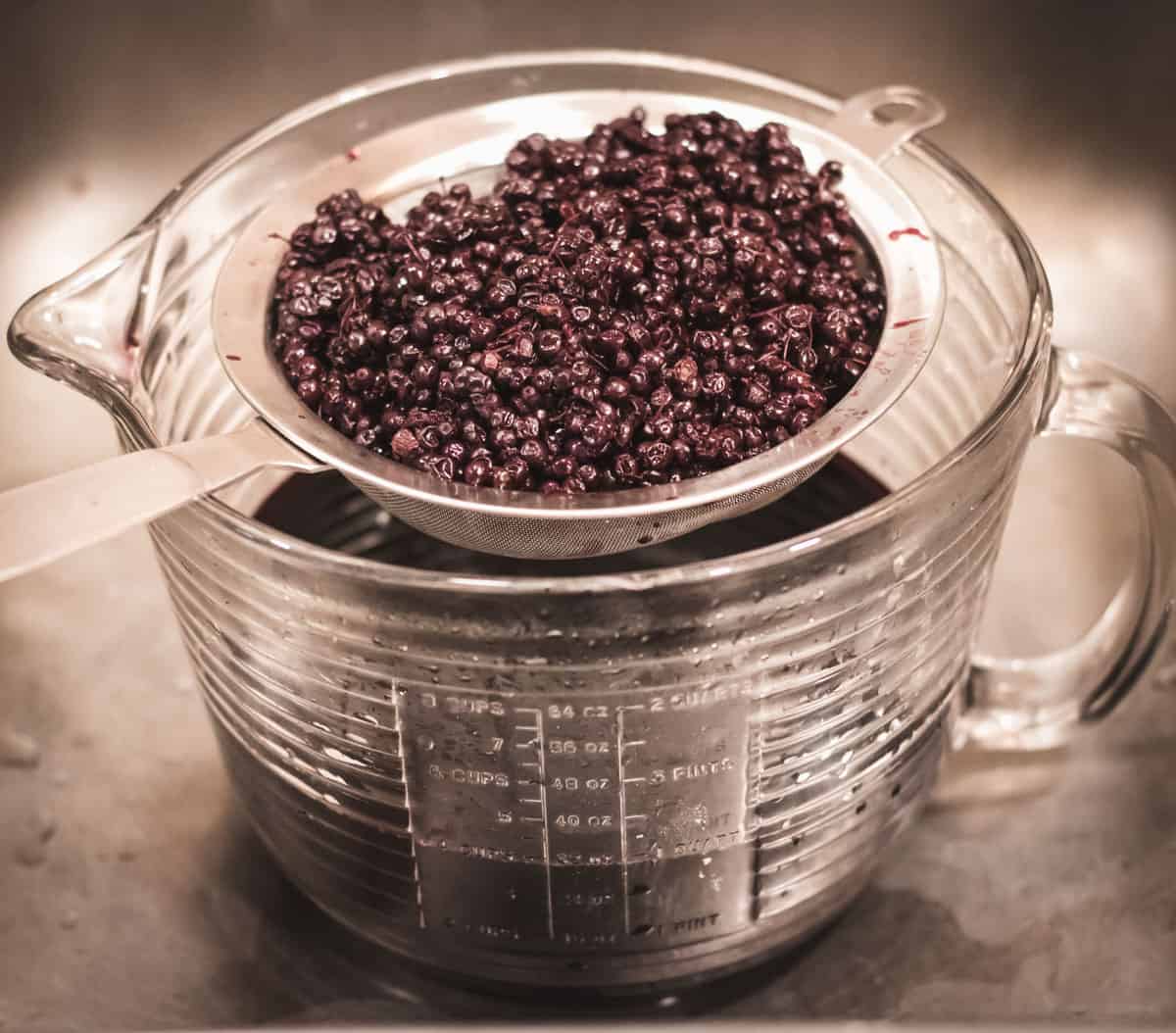 straining out the elderberries