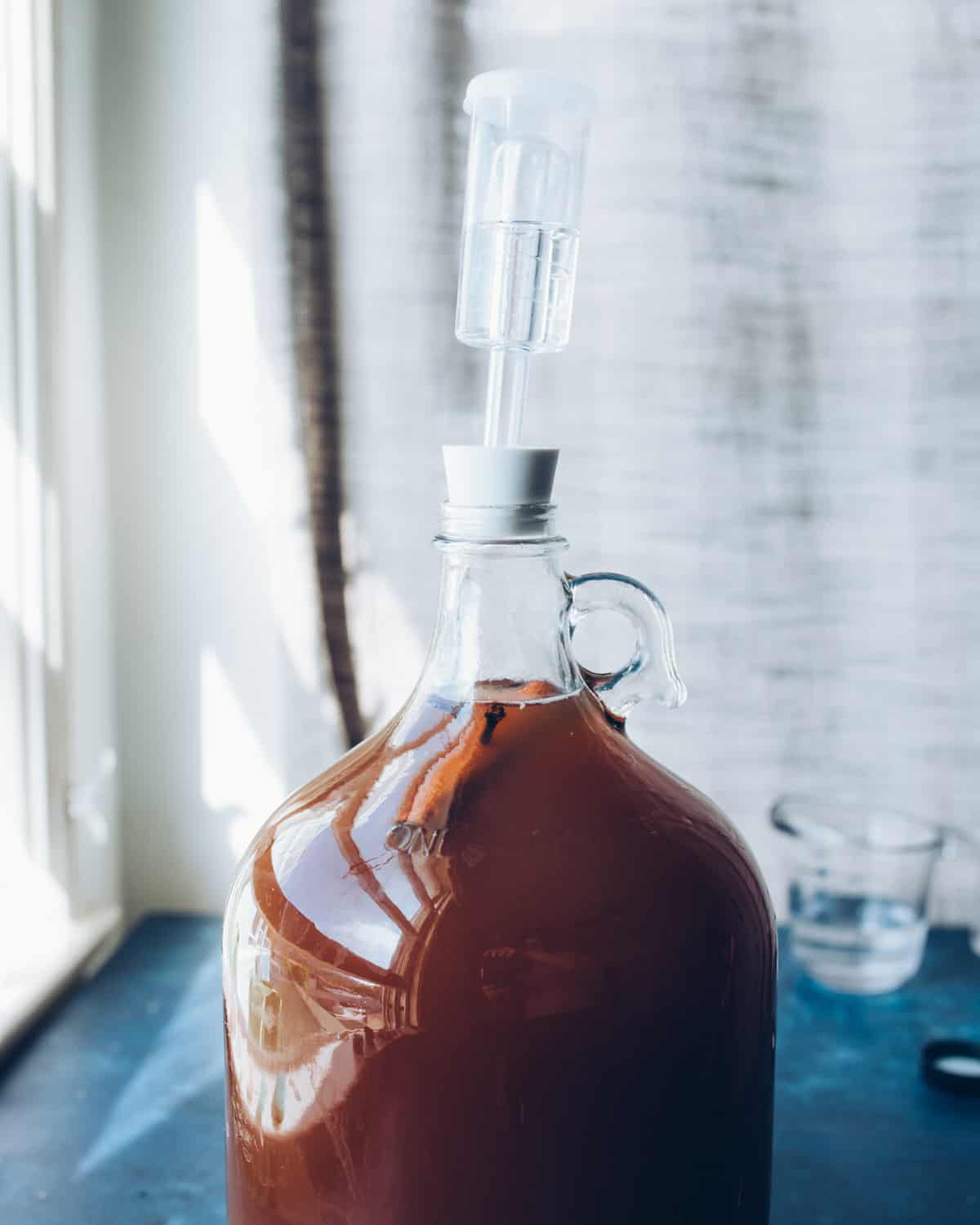 Hard cider fermenting in a jug with an airlock.