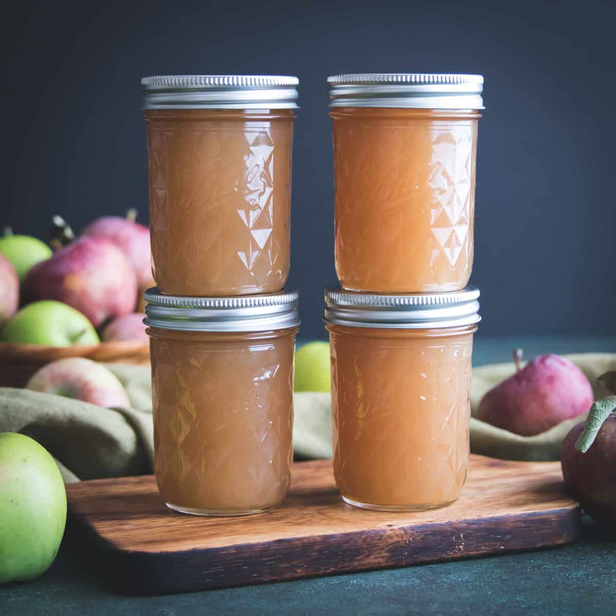 two stacks of two jars of homemade apple jelly