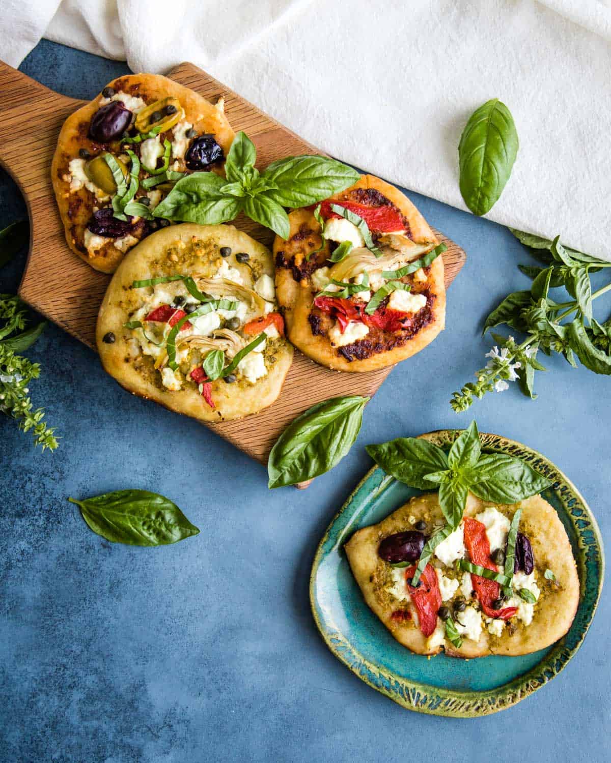 mini sourdough appetizer pizzas on a cutting board