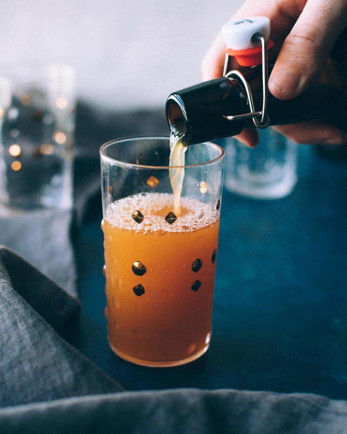 pouring hard cider from a bottle to a glass