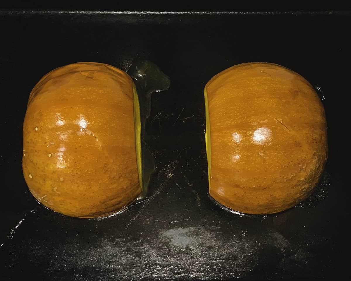roasted pumpkin halves on a sheet pan
