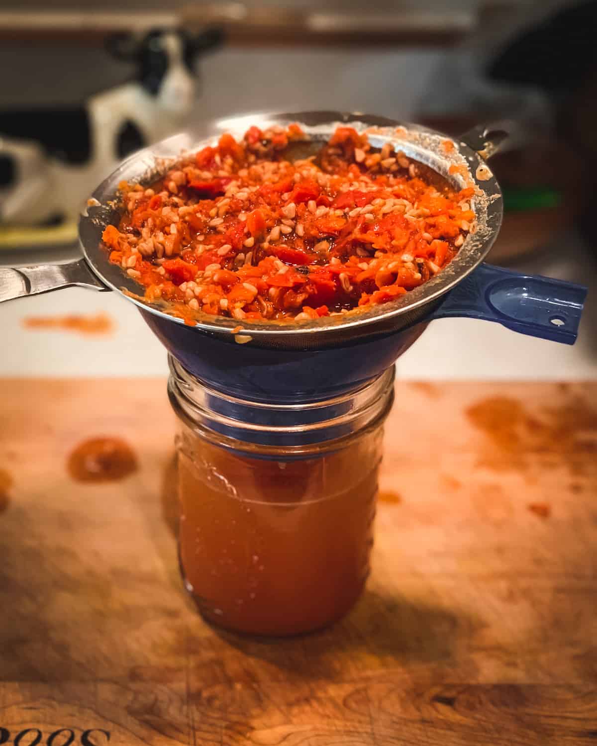 straining out the rose hip solids to make the tea