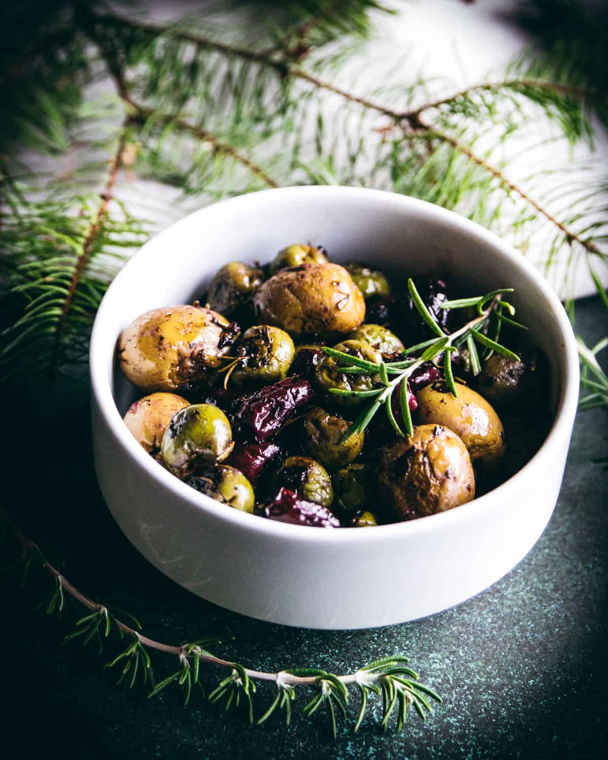 a bowl of roasted olives with rosemary