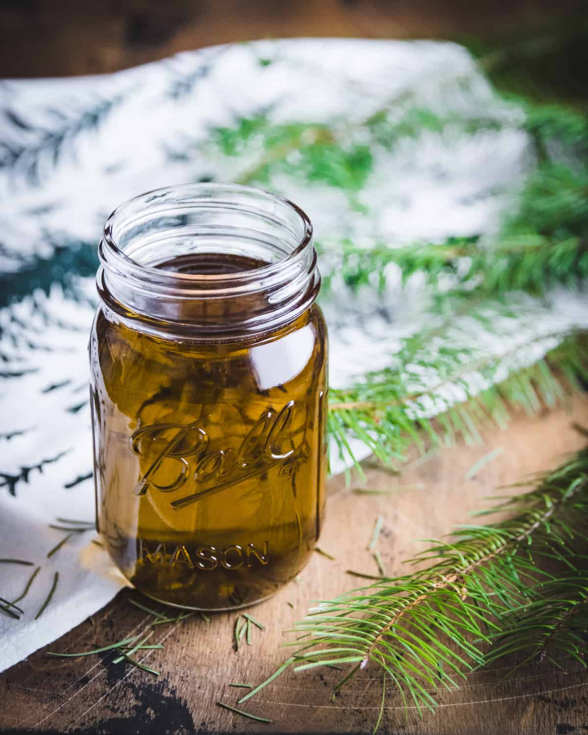 a ball jar filled with conifer infused oil