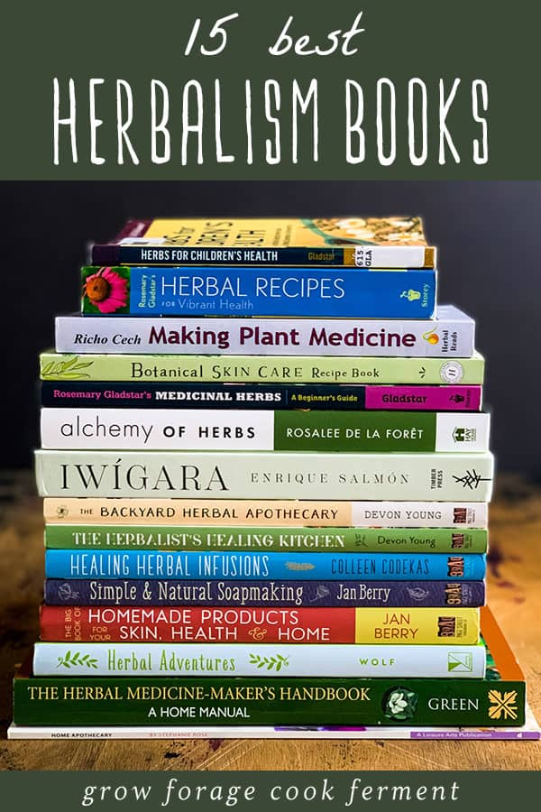 For beginning and more advanced herbalists alike, it’s important to have some books about herbs and herbal recipes on hand. I often get asked what my favorite herbalism books are, and there are so many great ones to choose from! I’ve narrowed it down to what I think are the 15 best books about herbalism and natural body care for you here. These books will give you a great start on how to make your own plant medicine! a stack of the best herbalism books