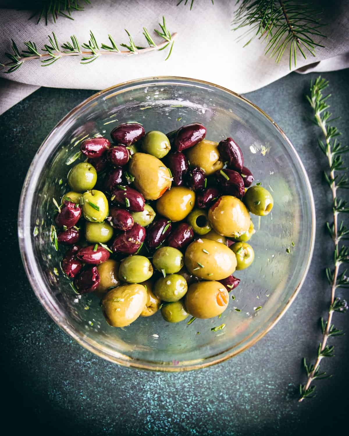 a variety of olives and other ingredients mixed together in a bowl