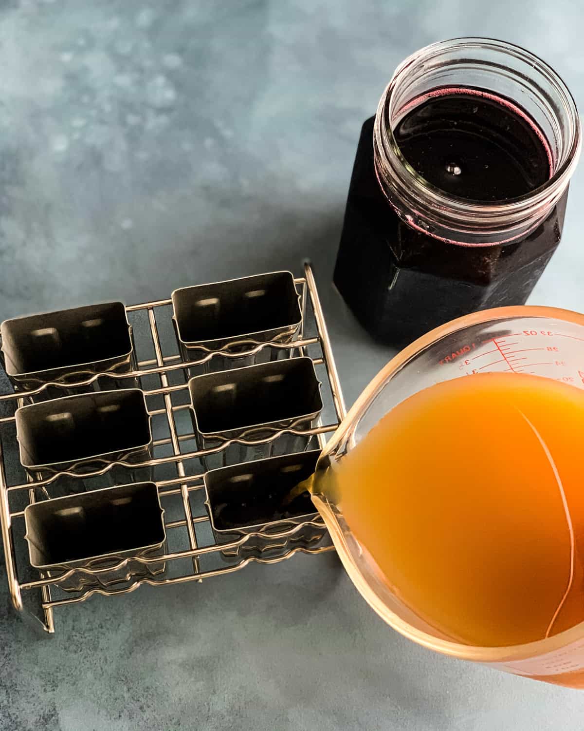 pouring apple juice into the popsicle molds