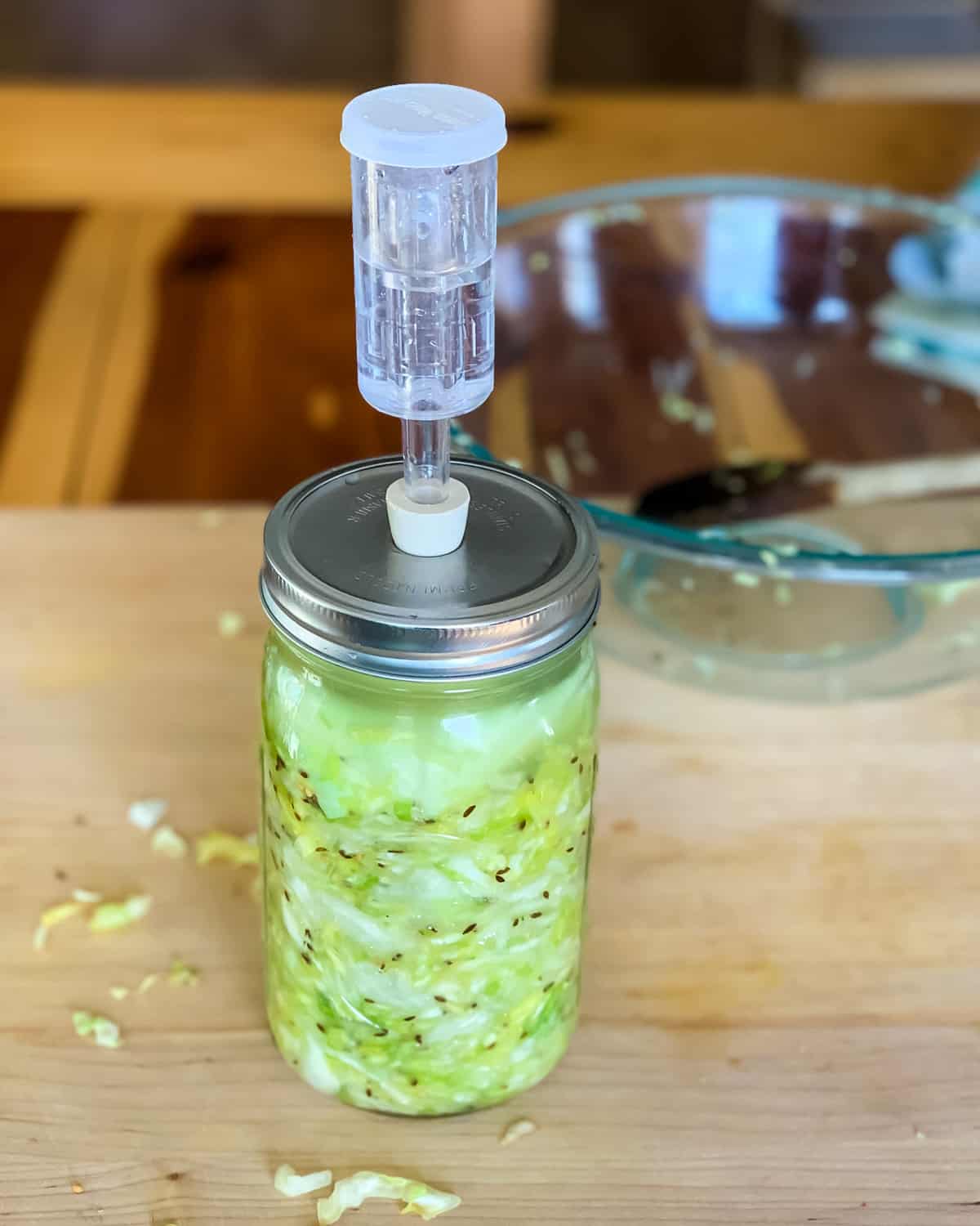 putting the airlock onto the jar of sauerkraut