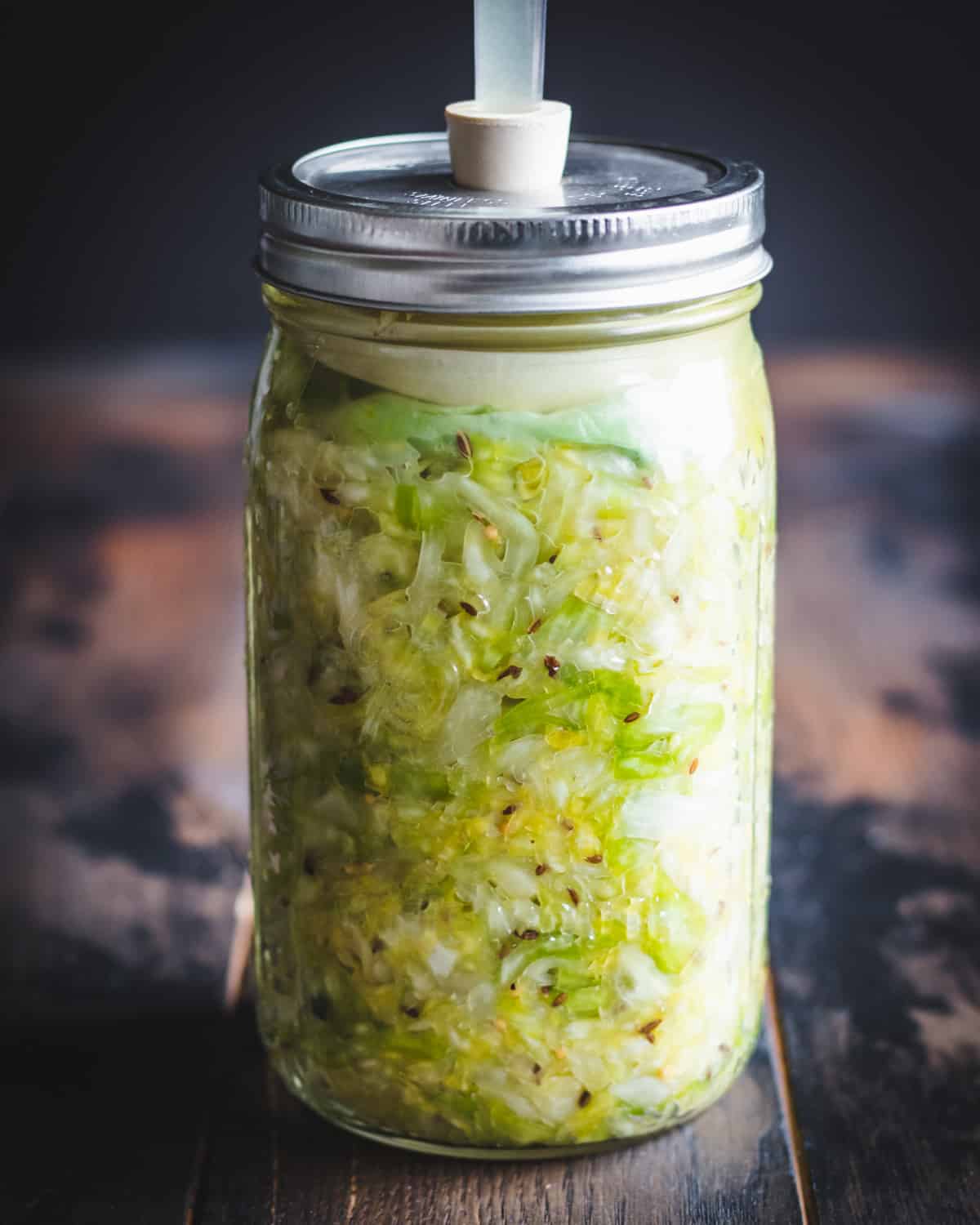 a quart jar of sauerkraut fermenting