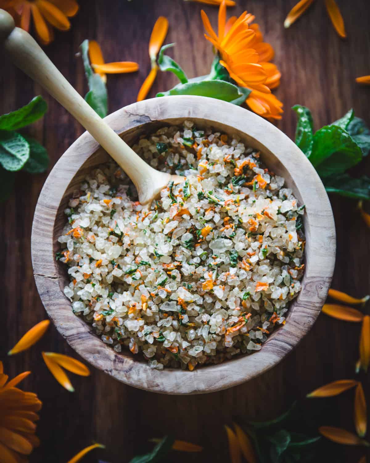 top view of a bowl of herbal bath salt with calendula and mint