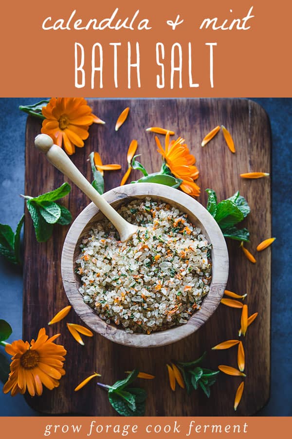 calendula and mint herbal bath salt in a wooden bowl