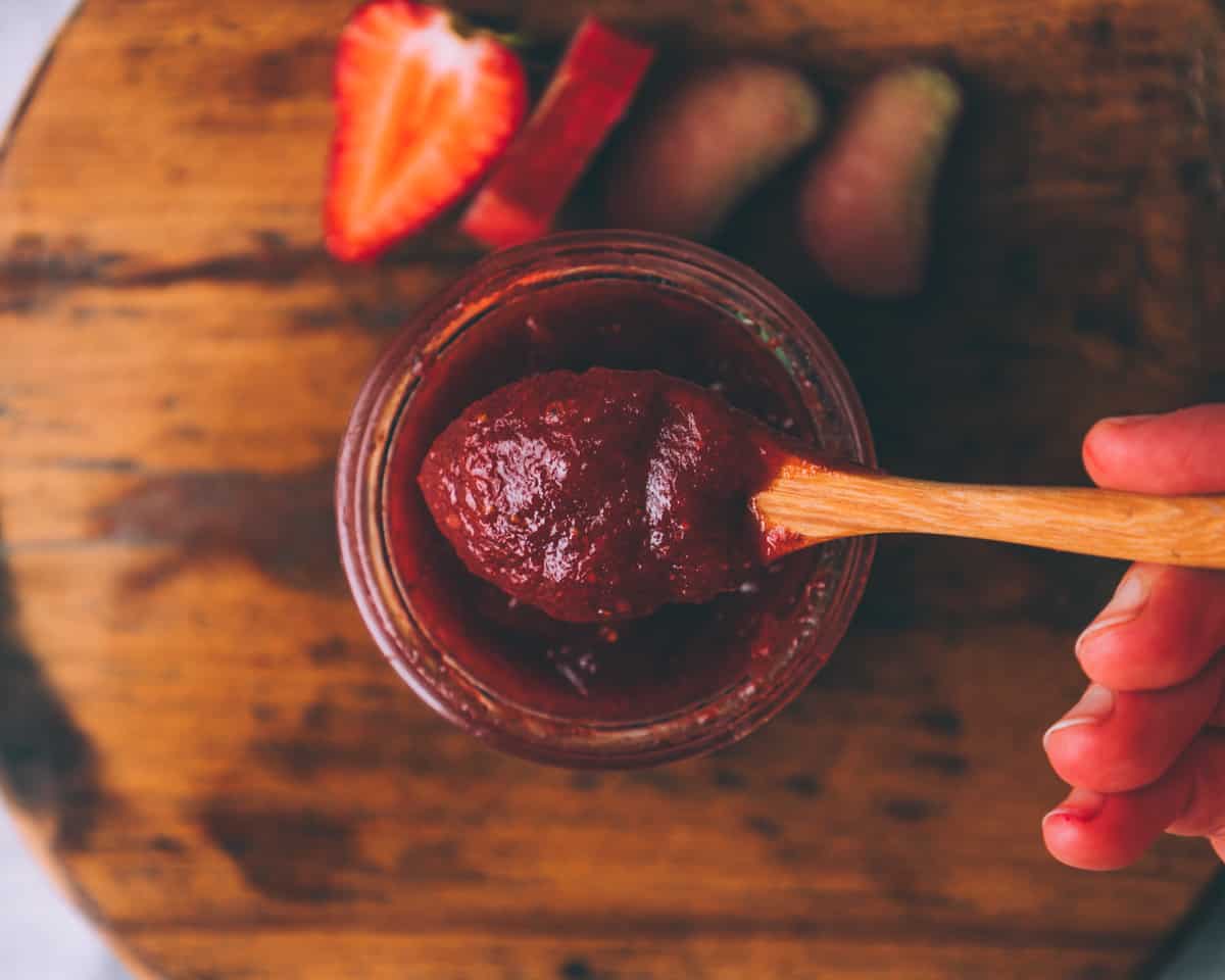 a spoon with strawberry rhubarb butter