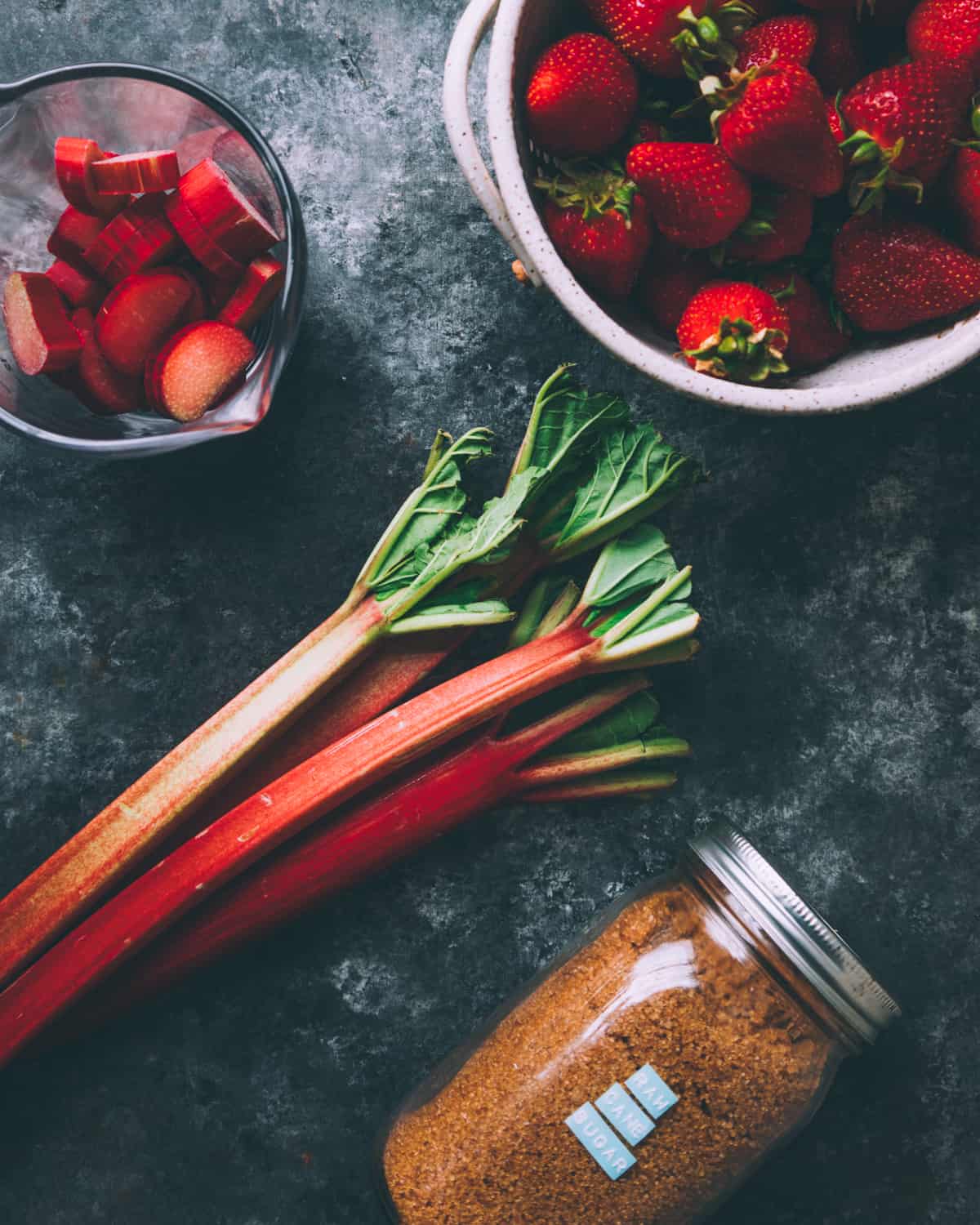 rhubarb, strawberries, and sugar on a table