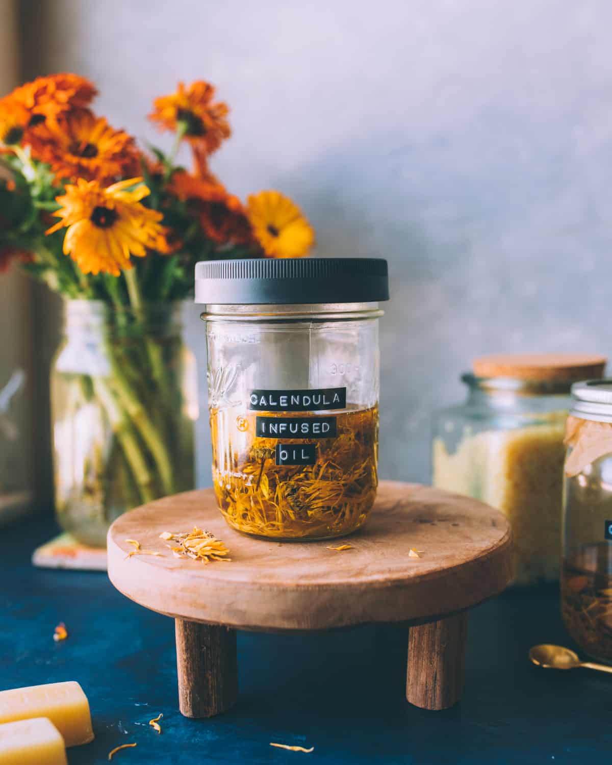 A covered jar of calendula infused oil, with a lid on. 