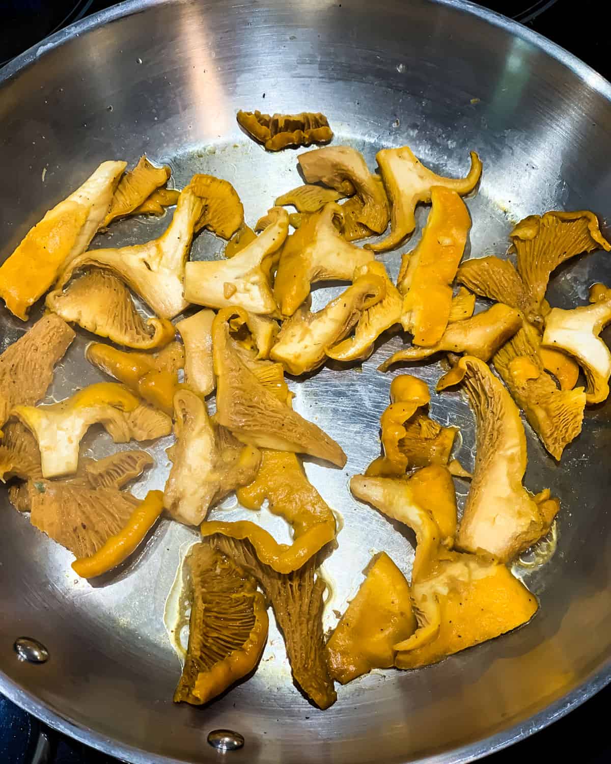 chanterelles cooking in a pan with butter