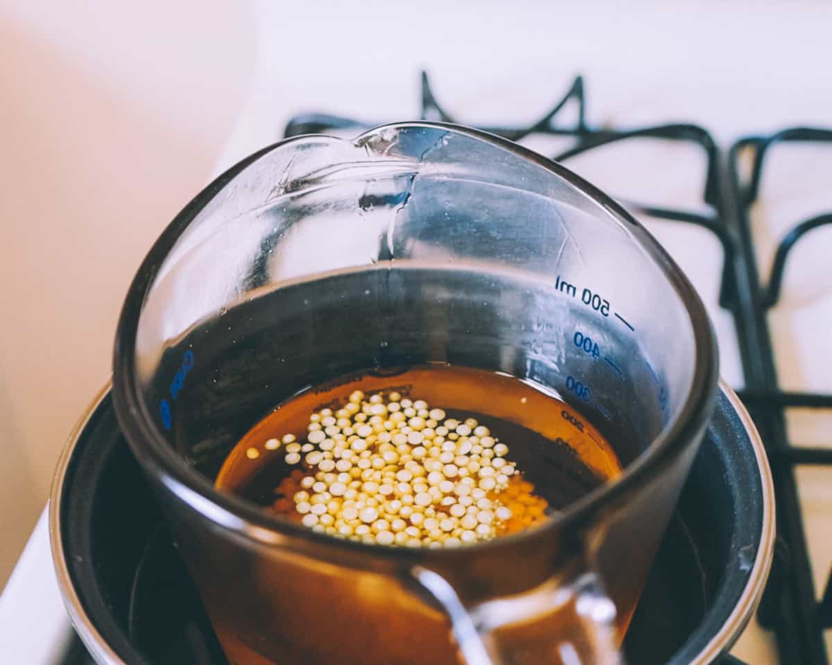 Beeswax melting in calendula oil on a makeshift double boiler on a gas stove. 