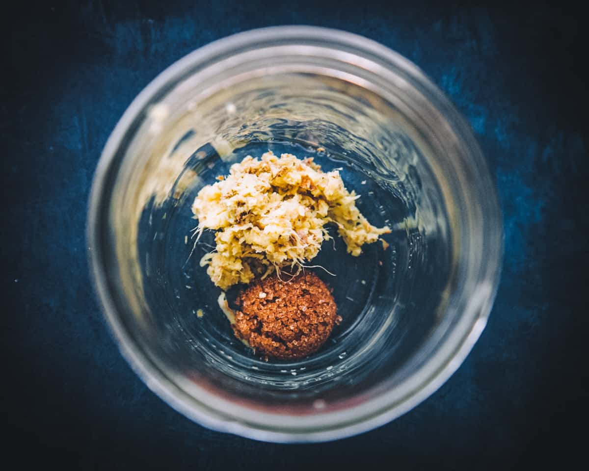 top view of a jar with grated ginger and sugar inside