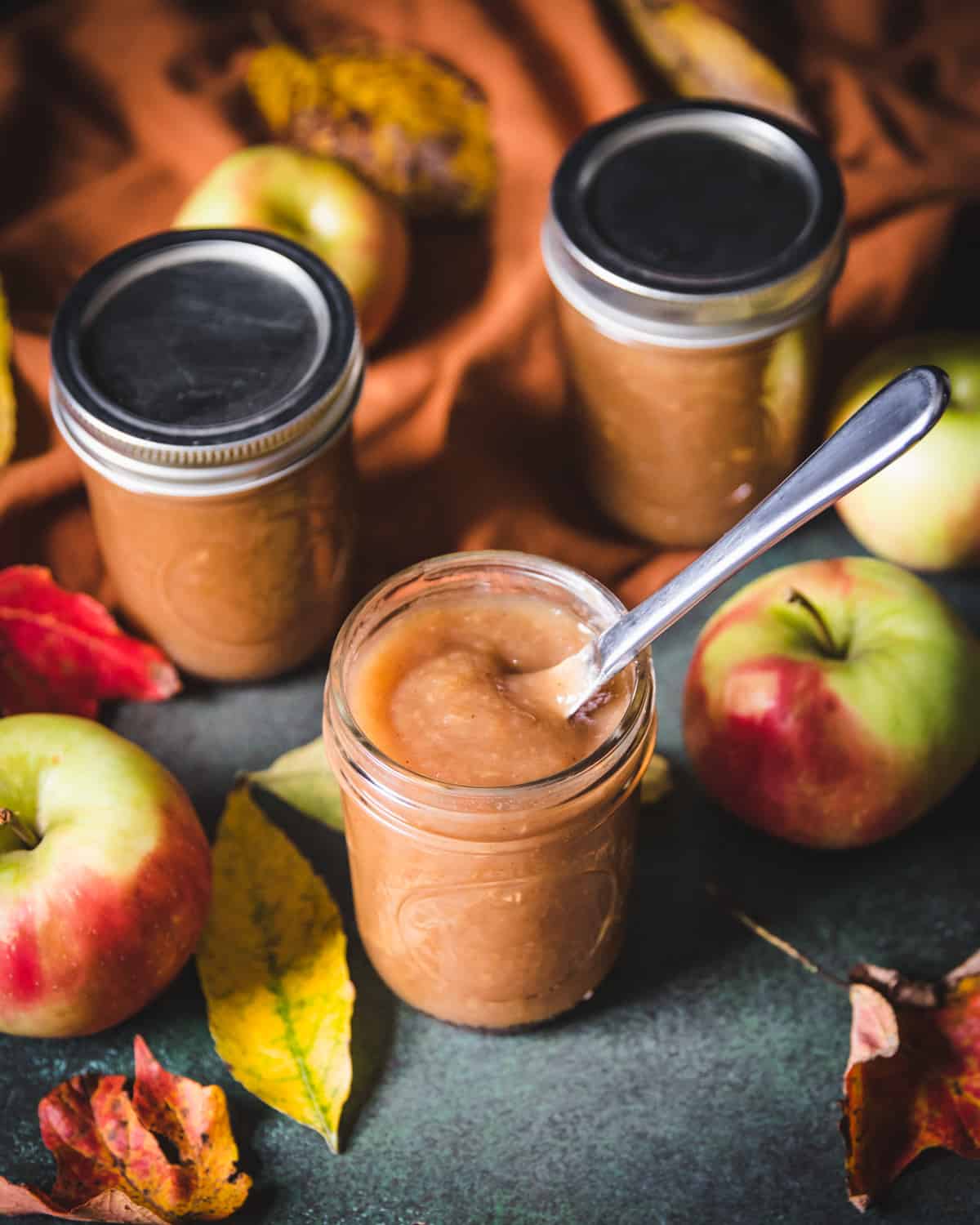 a jar of spiced apple butter with a knife