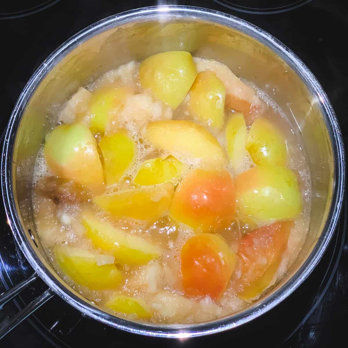 a pot of apples cooking on the stove