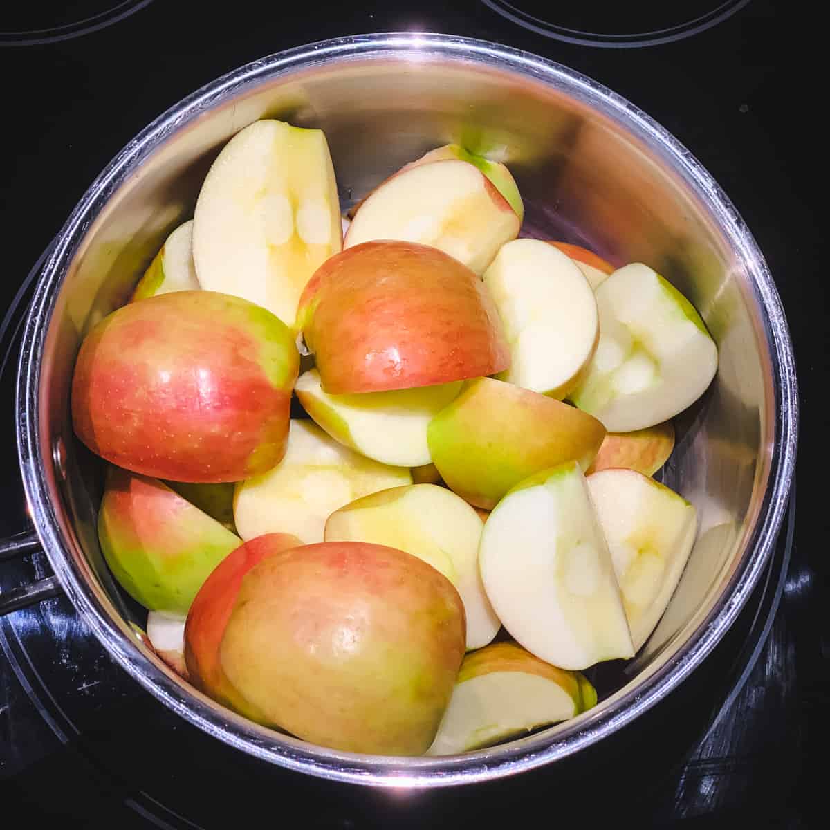 a pot of fresh quartered honeycrisp apples with the skins on