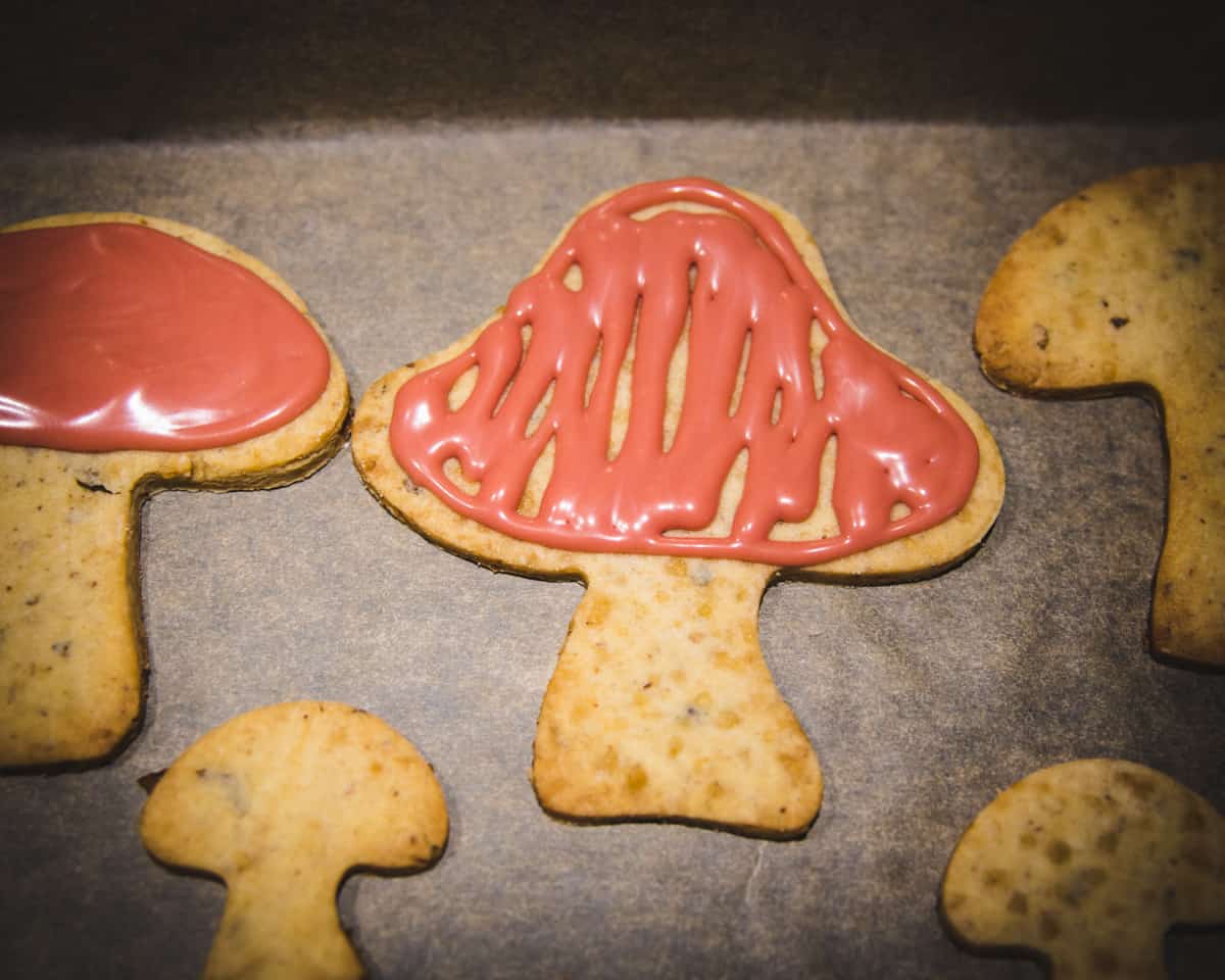 decorating mushroom cookies with red maple syrup icing