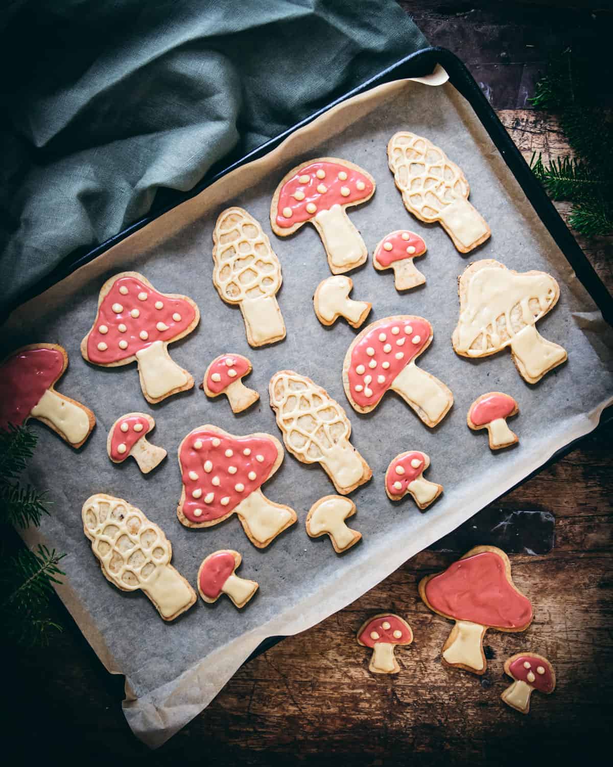 a sheet pan with parchment paper and various mushroom cookies