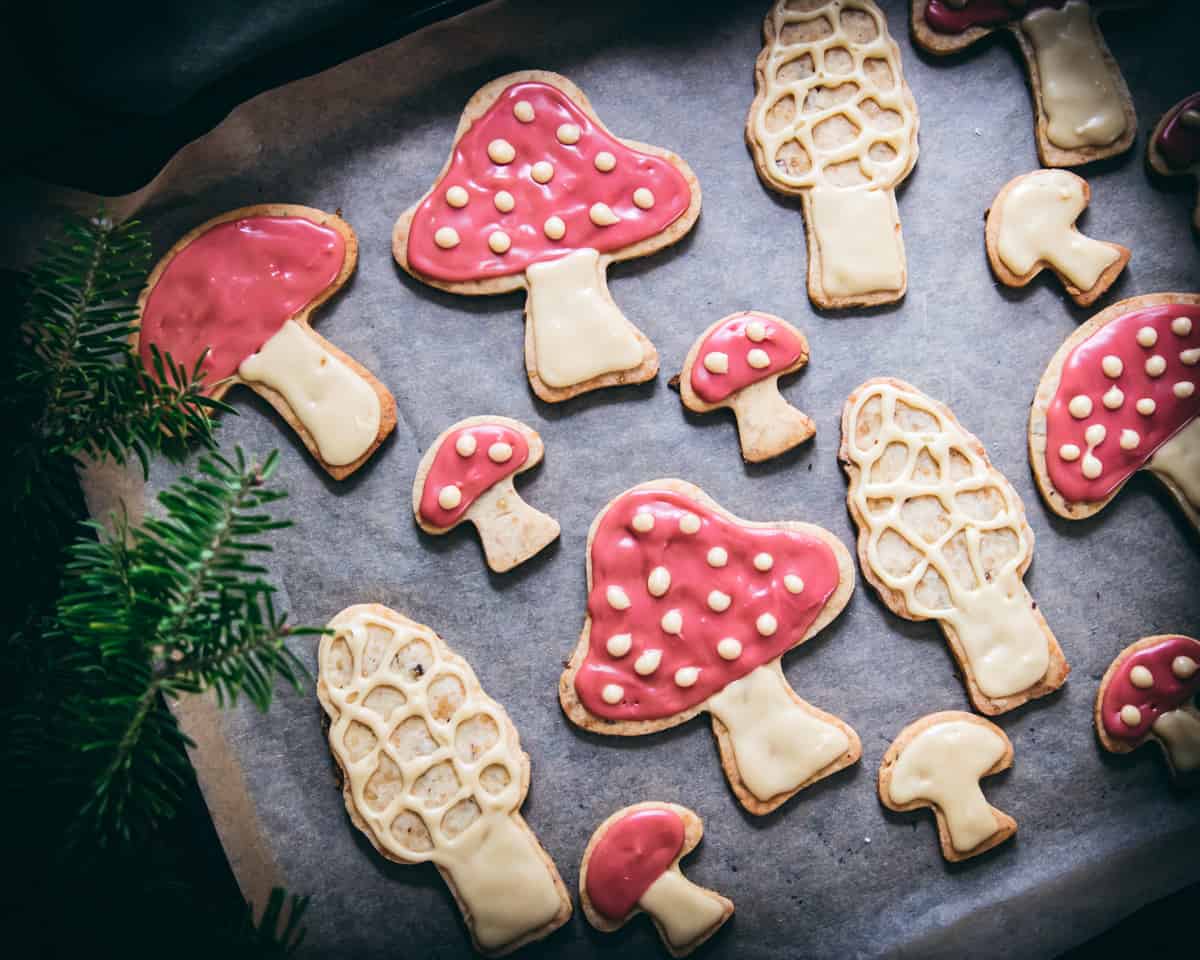 amanita and morel mushroom cookies on a sheet pan with parchment paper