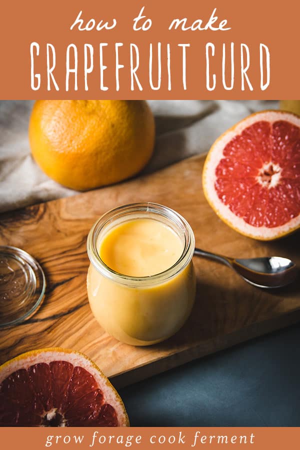 a jar of grapefruit curd on a wooden cutting board