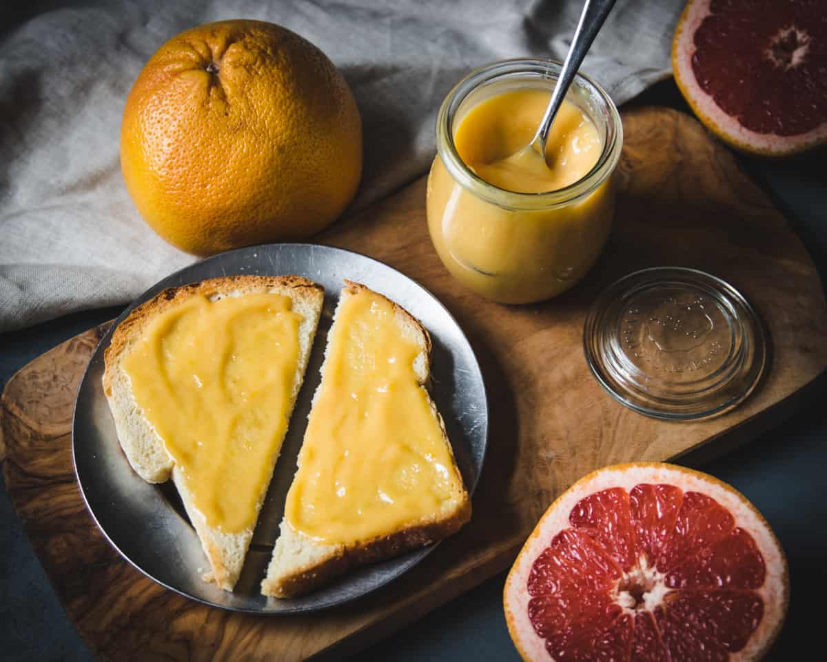 sourdough toast on a metal plate with grapefruit curd