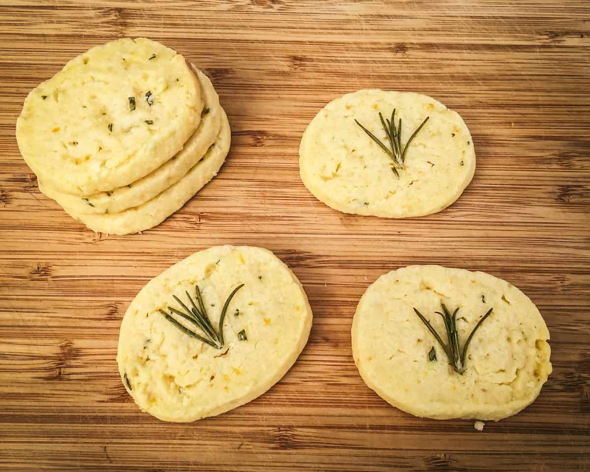 a stack of lemon and rosemary shortbread cookies along with three more cookies