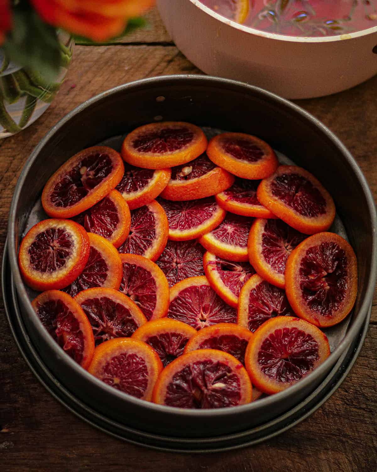 Blood orange slices layered in a springform pan.
