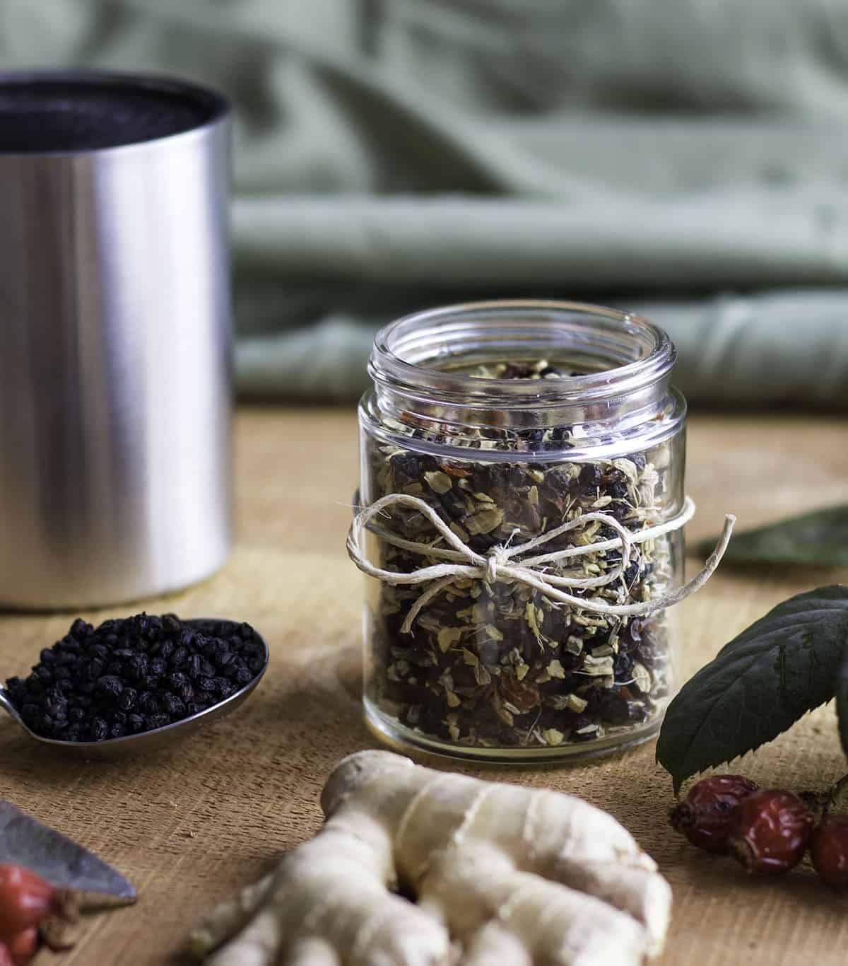 a jar of immune boosting tea blend wrapped with a twine bow