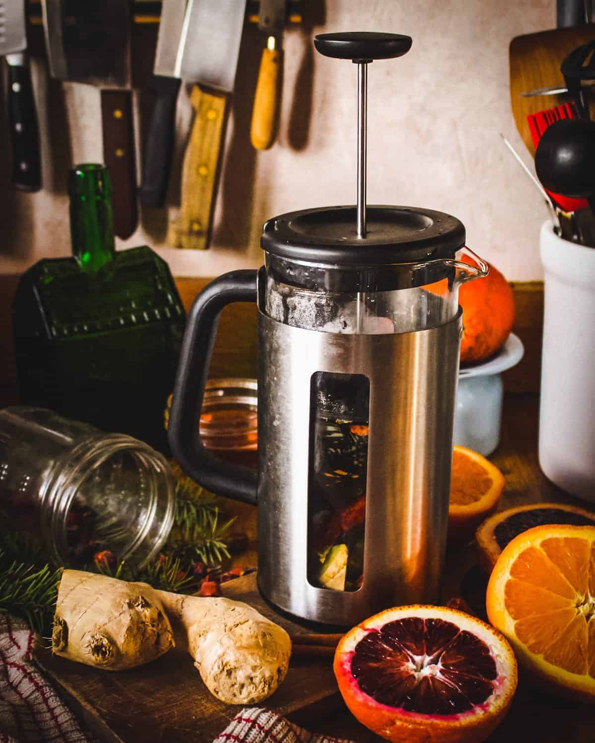 a french press with the conifer tea mixture steeping