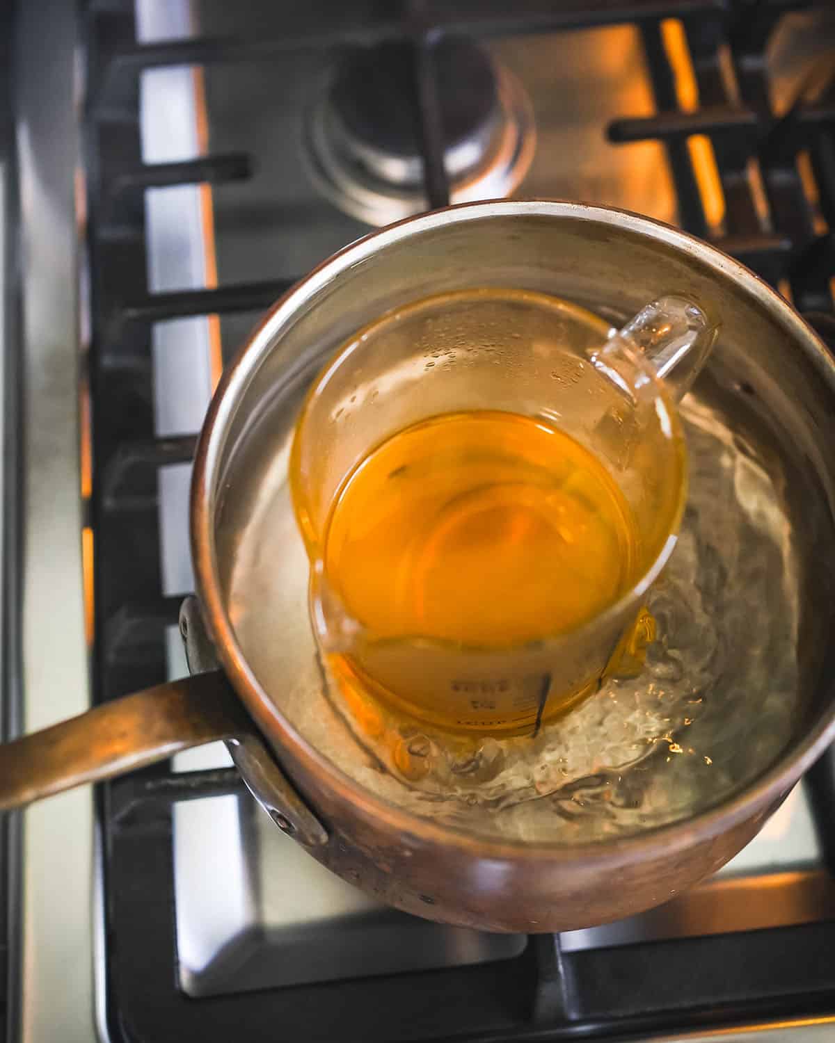 Melting beeswax in a double boiler pot. 