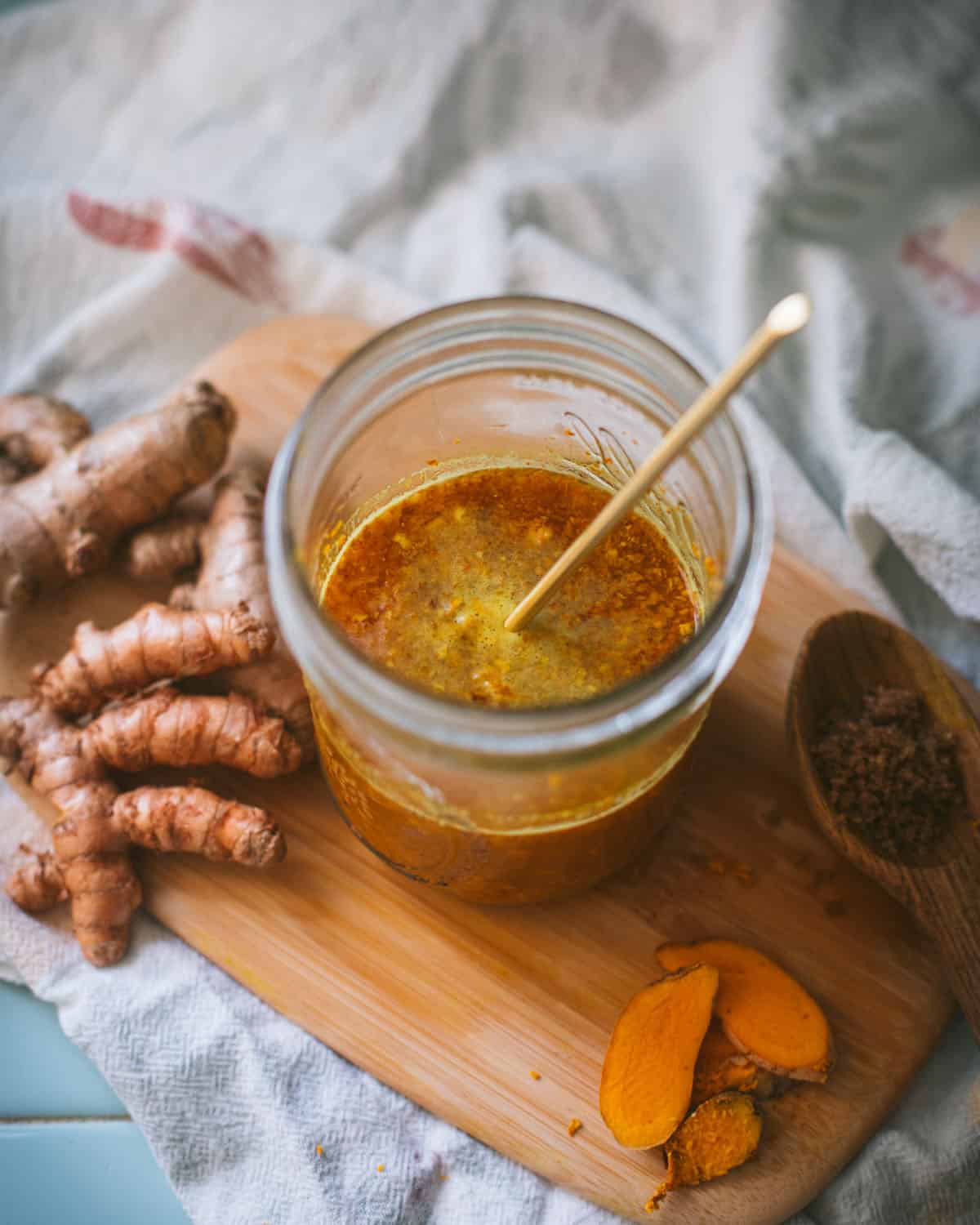 a jar of bubbly turmeric bug with a stir stick