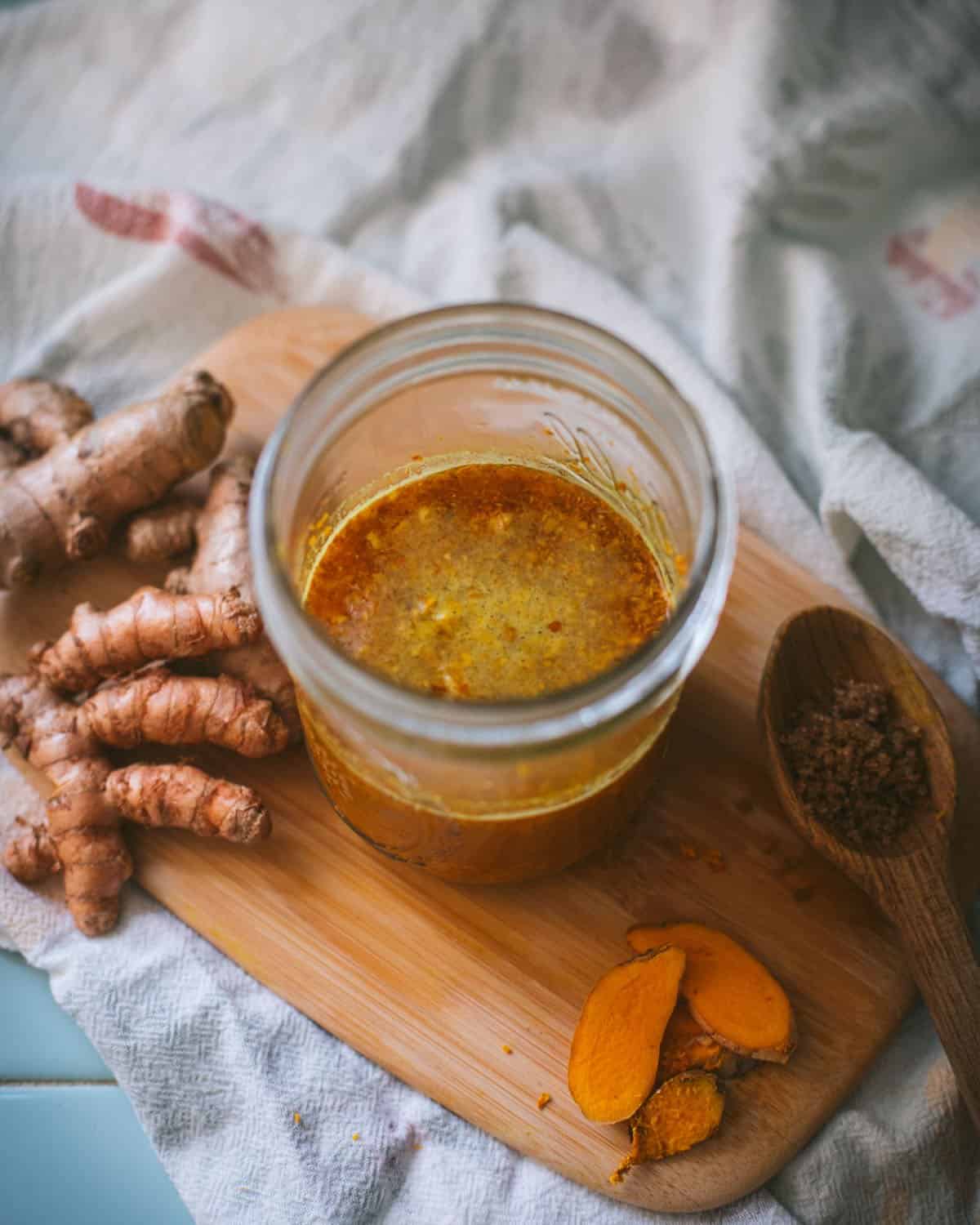 a jar of turmeric bug with bubbles on the surface