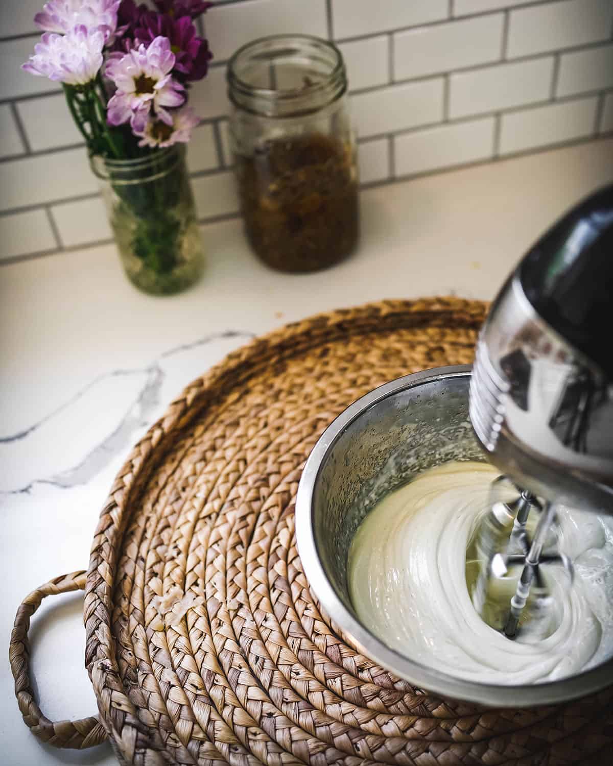 Oils being whipped into a body butter texture with a hand mixer.