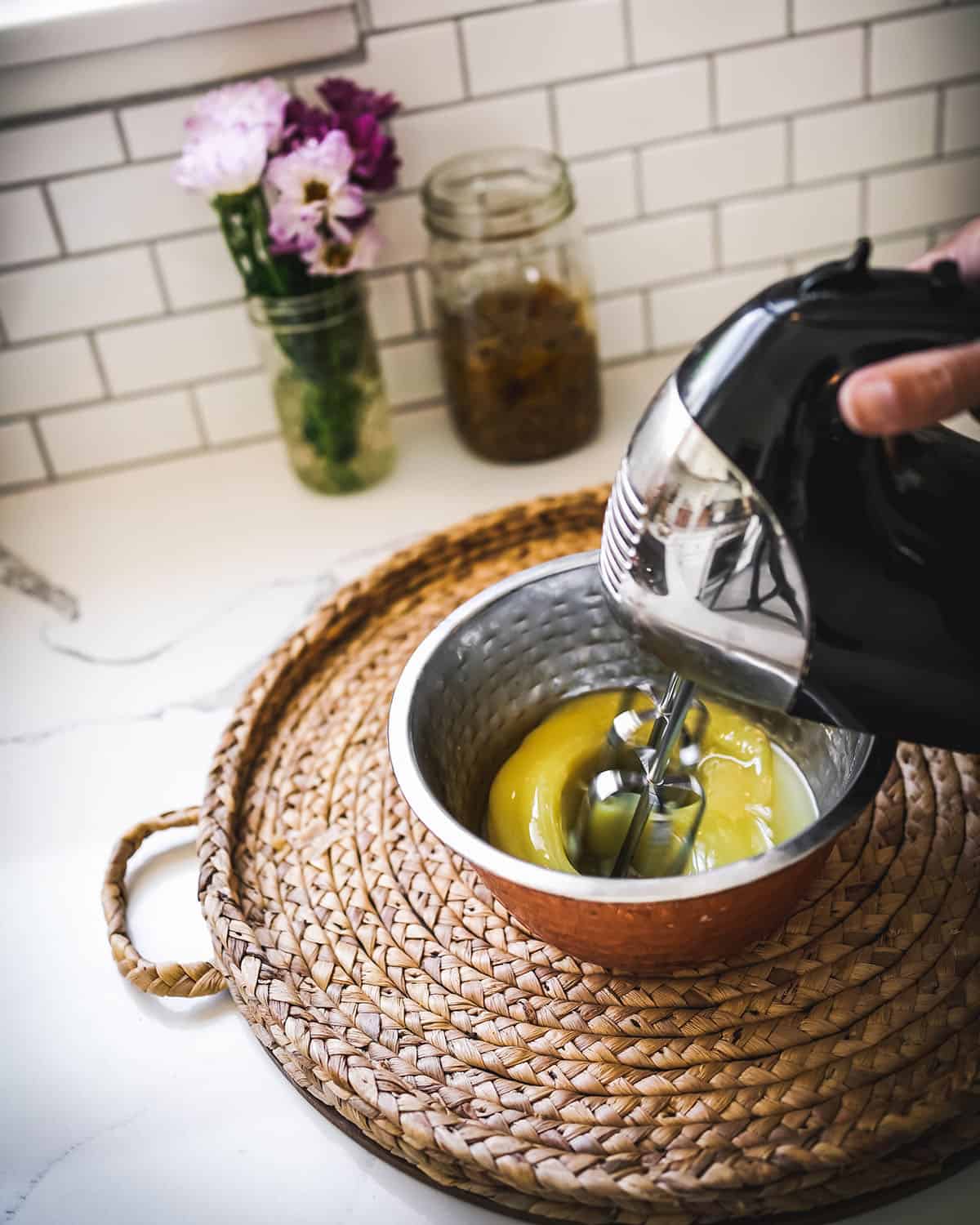 Cooled oils being whipped with a hand mixer.