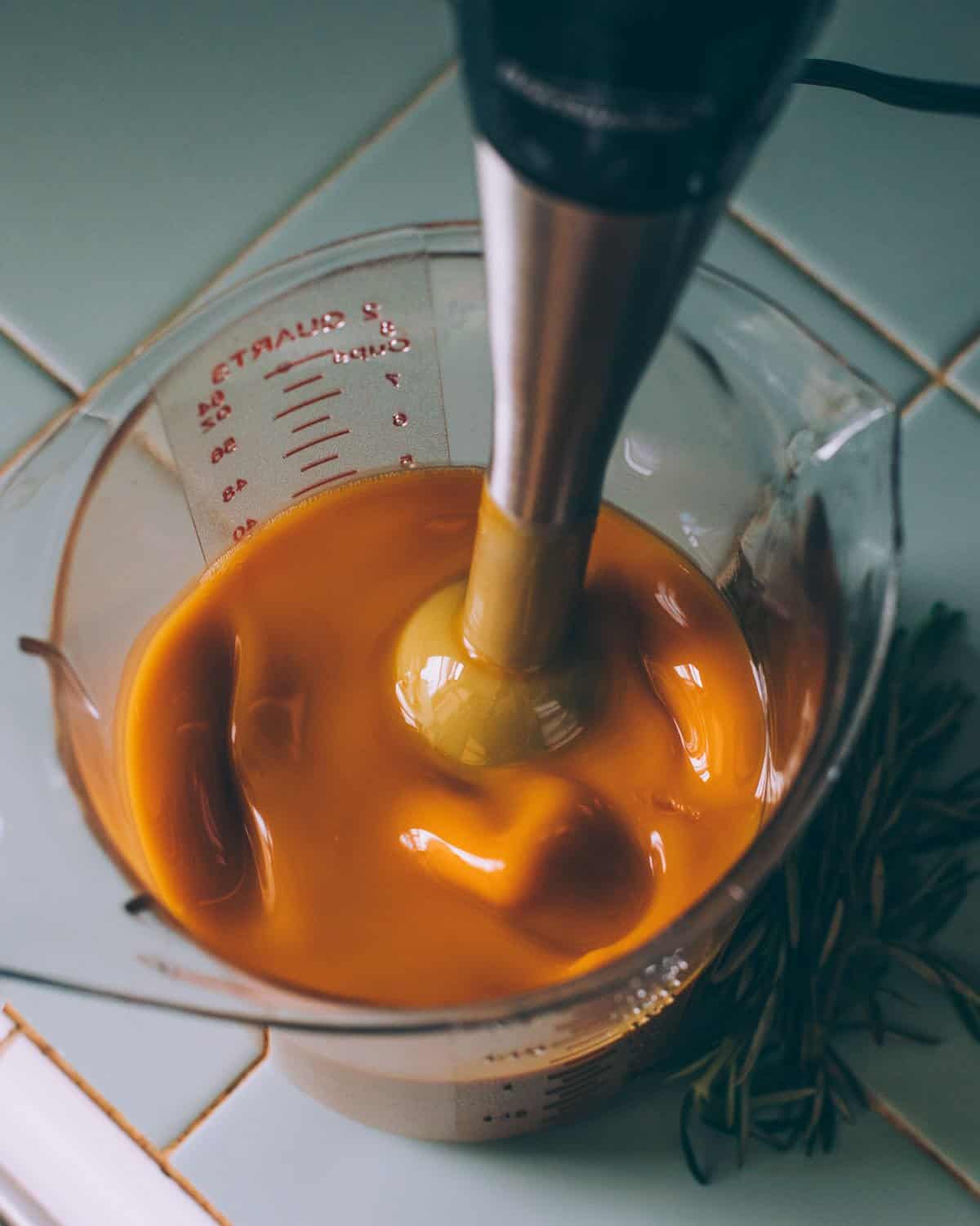 blending the shampoo bar batter with a stick blender