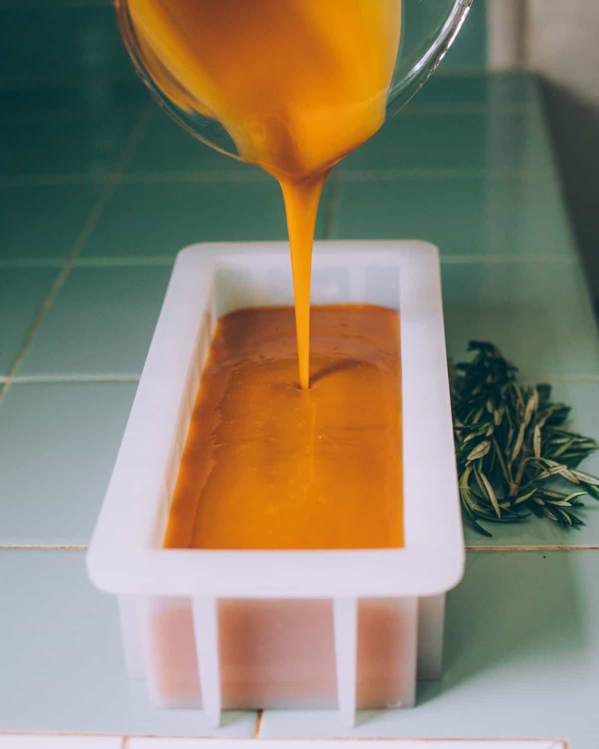 pouring the shampoo bar batter into a soap mold