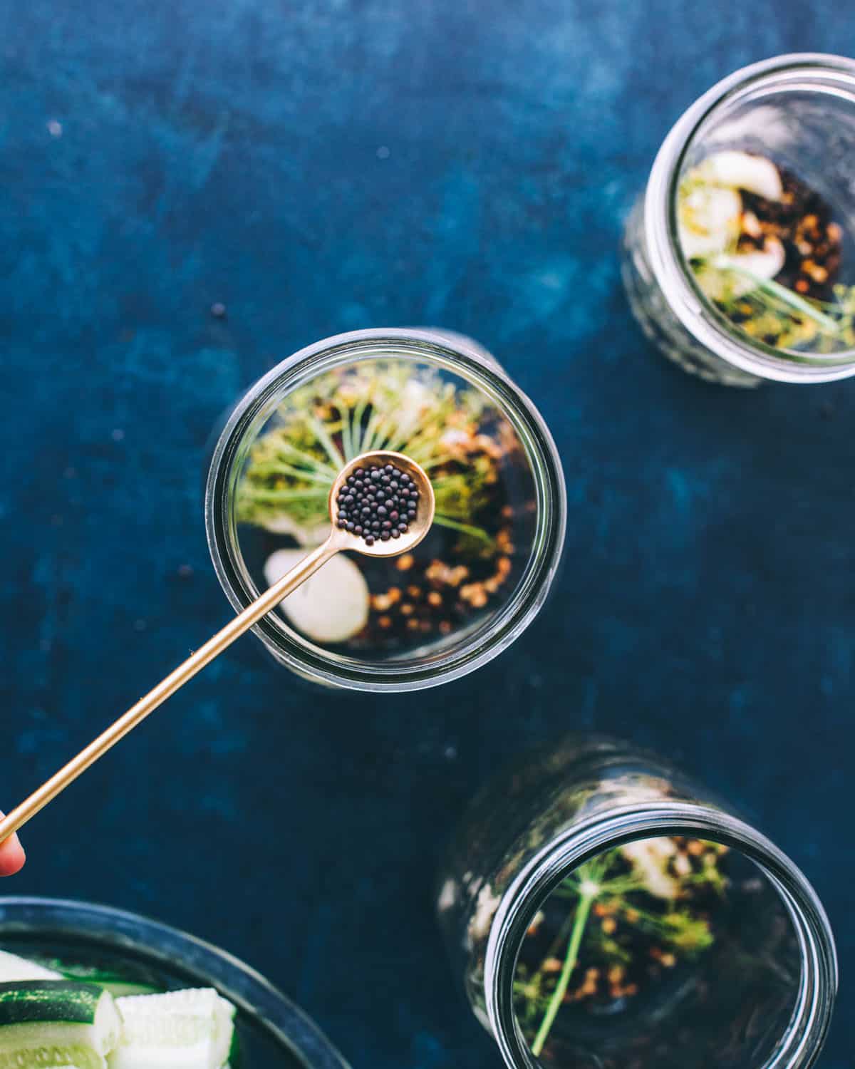 Spices being added onto the pickling jars. 