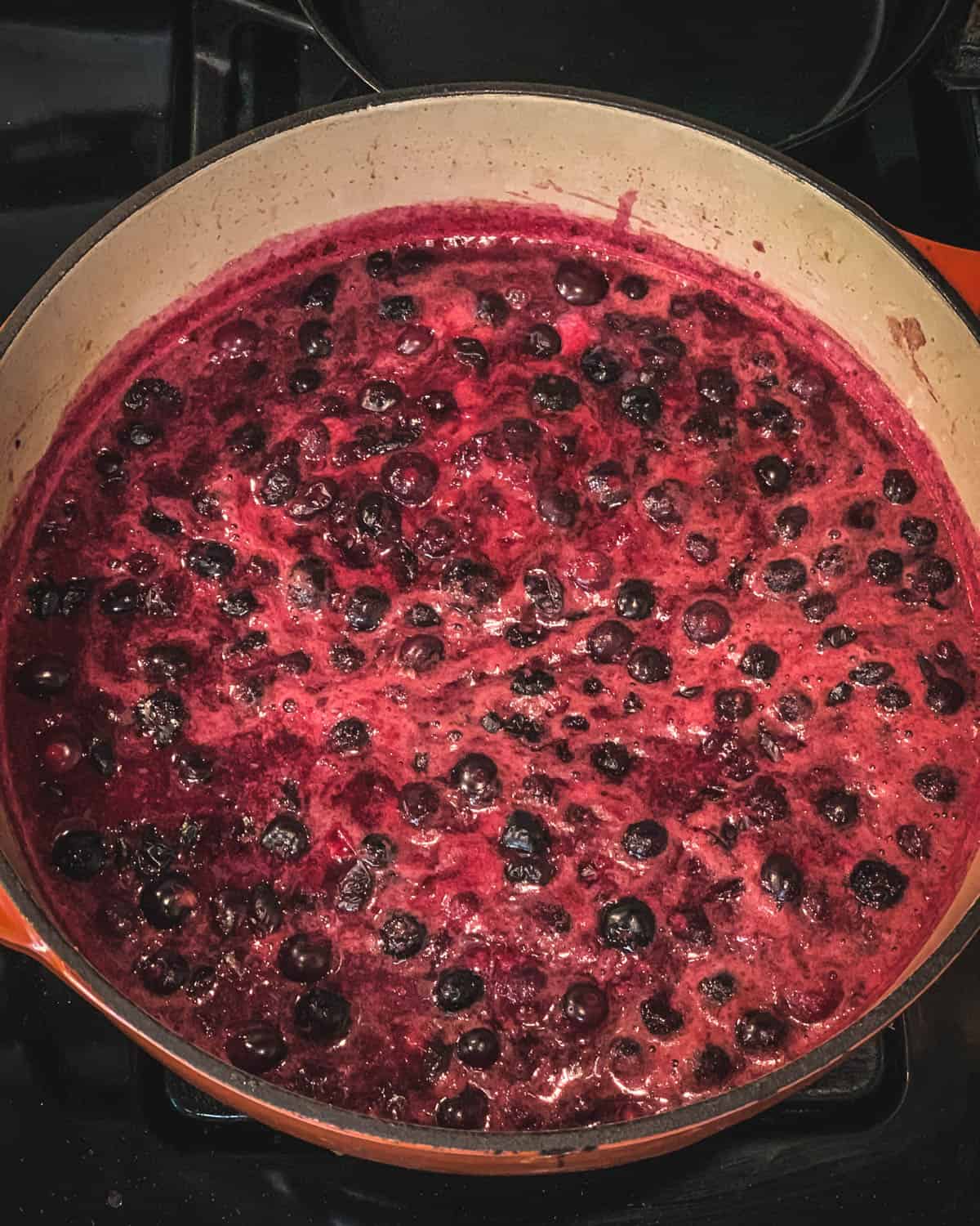 A pot of boiling blueberries to make jam. 