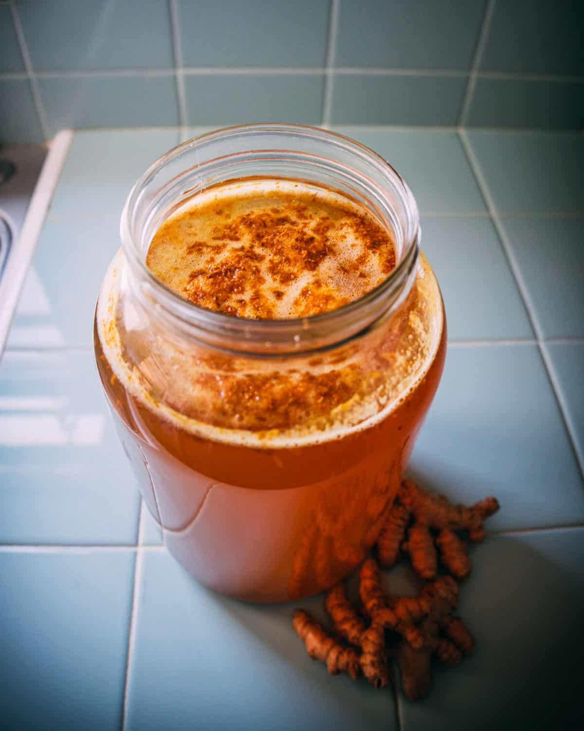 Turmeric soda bubbling in a gallon jar. 