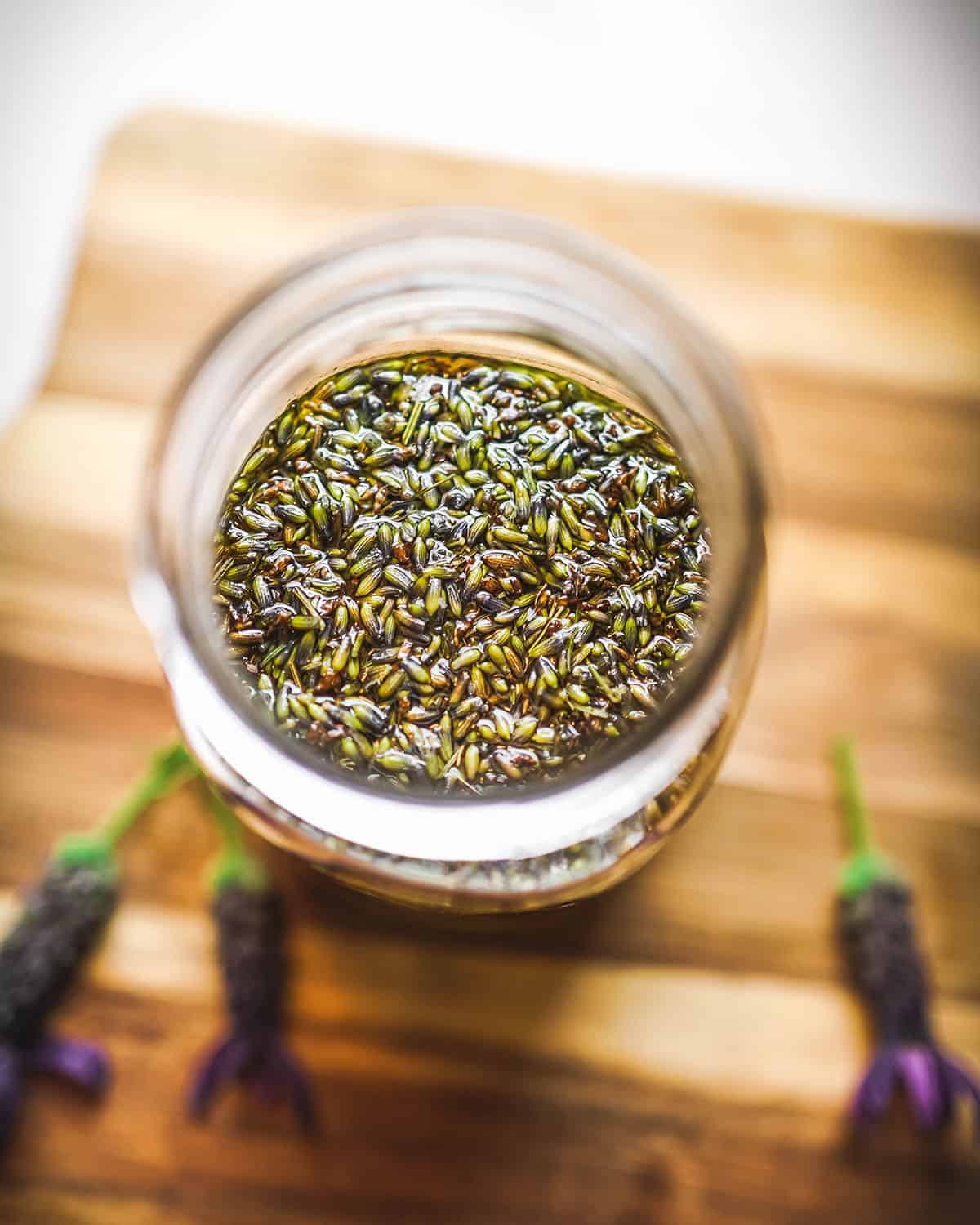 Lavender oil infusing in a jar, top view.