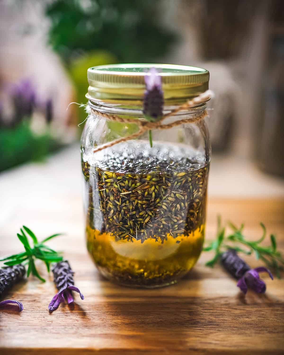 A jar with a lid infusing lavender oil. 