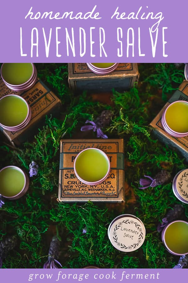 Several tins of lavender salve surrounded by lavender, and a purple banner on top that reads homemade healing lavender salve. 