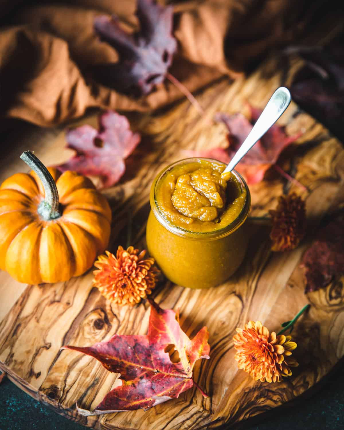 Pumpkin butter in a jar with a spoon. 