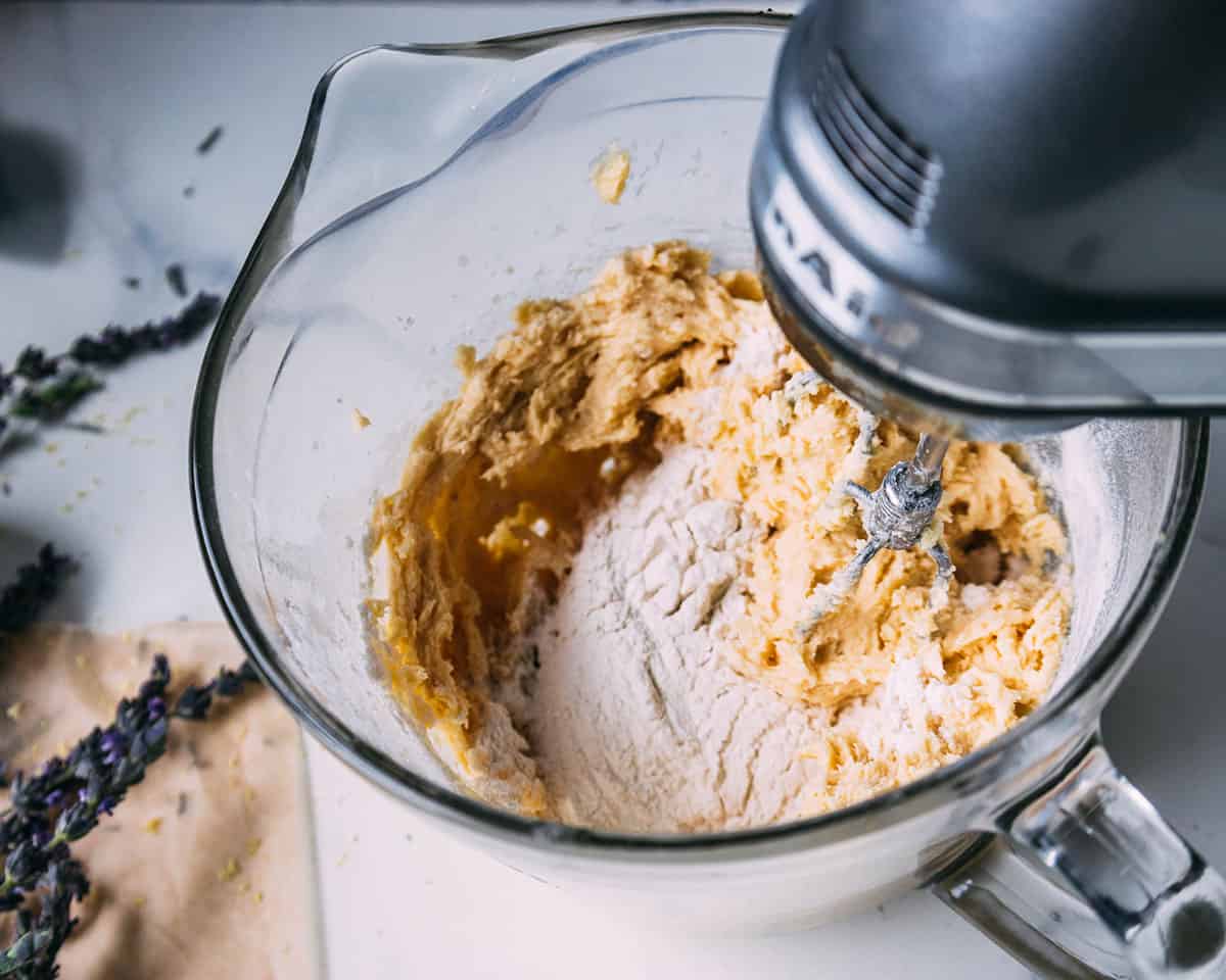 A stand mixer creaming together the butter and sugar.